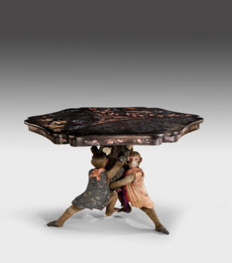 antique table monkey holding it up