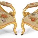A pair of high Victorian gilt wood and needlework arm chairs by Gillows