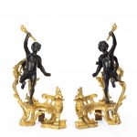 A pair of late 19th century ormolu and bronze chenets back