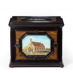 A fine quality ebony bijouterie table cabinet showing Cavalry Church, Stonington, Long Island top closed