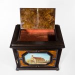 A fine quality ebony bijouterie table cabinet showing Cavalry Church, Stonington, Long Island top open