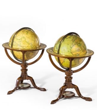 A pair of Carys 12 inch library table globes in mahogany stands