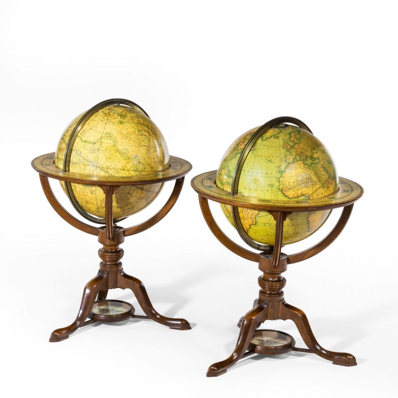 A pair of Carys 12 inch library table globes in mahogany stands