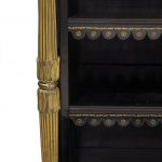 A Regency brass-inlaid ebonized breakfront bookcase