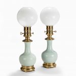 A pair French porcelain and ormolu mounted oil lamps by Gagneau