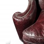 A large George I style burgundy leather wing arm chair