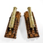 A pair of brass 19th century models of ship’s 32-pounder cannon top view