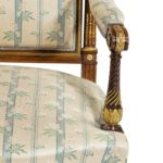 A pair of rosewood Louis XVI style open armchairs close up