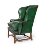 A George III green leather wing arm chair