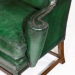A George III green leather wing arm chair