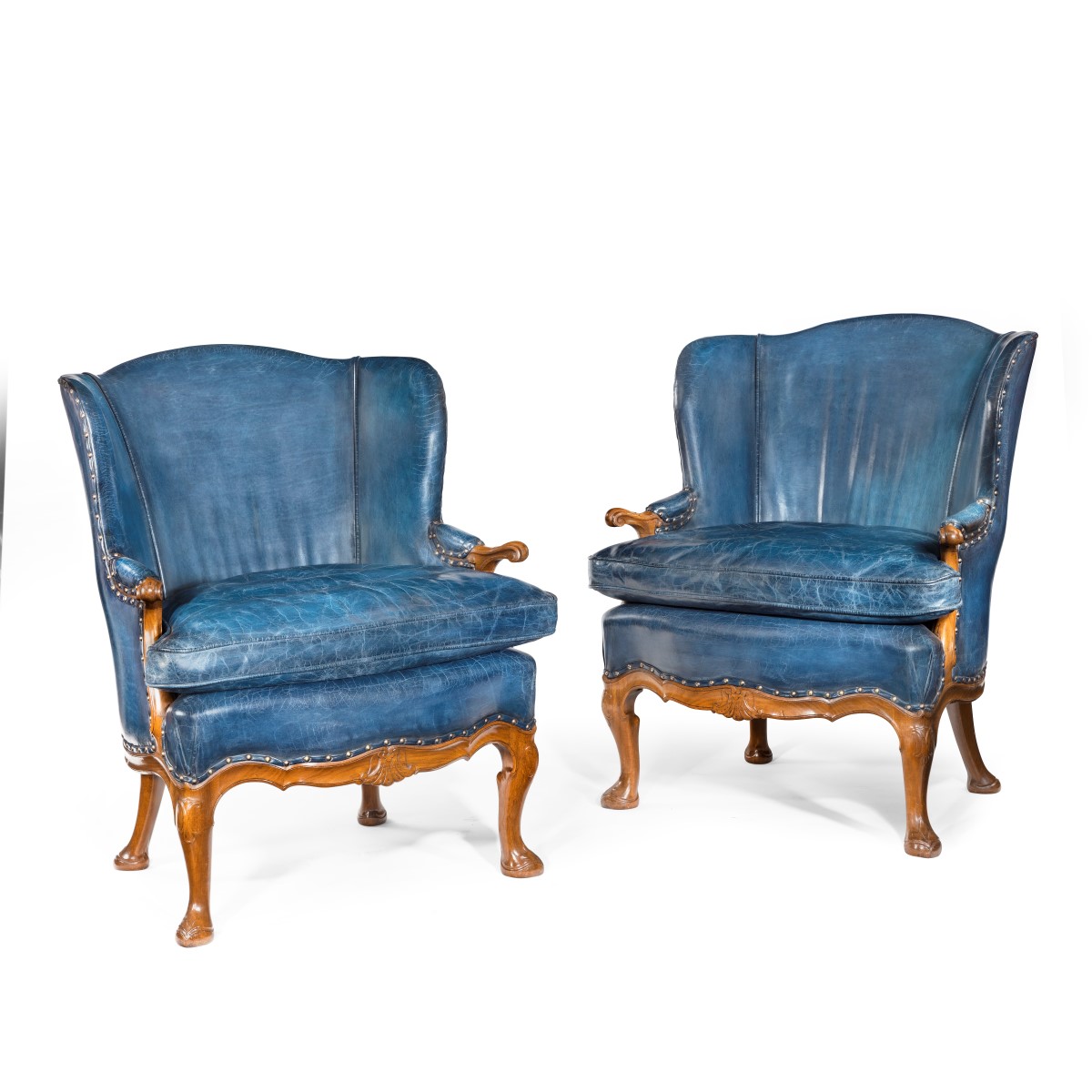 A pair of very generous mahogany wing armchairs attributed to Whytock and Reid, Edinburgh