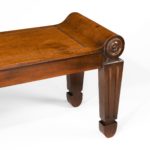A pair of George III mahogany hall benches close up