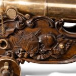 A pair of bronze cannon at the Battle of Waterloo closeup wood detail