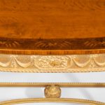 A pair of Victorian Hepplewhite style satinwood console tables closeup gold detail