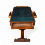 A Regency mahogany end support library table open