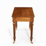 A mid-Victorian free-standing walnut writing table by Holland and Sons side