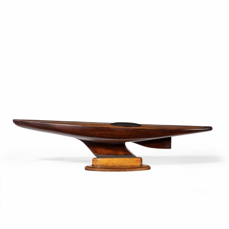 An Unusual static model of a marble head pond yacht stood upon its original shaped oak stand.