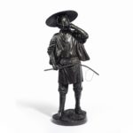 A Meiji period bronze of a cricket catcher statue