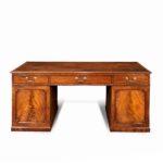 A late George III mahogany partner’s desk front