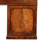 A late George III mahogany partner’s desk top detail