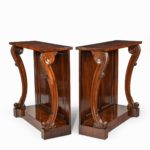 A pair of late Regency flame mahogany console tables sides