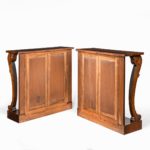 A pair of late Regency flame mahogany console tables back