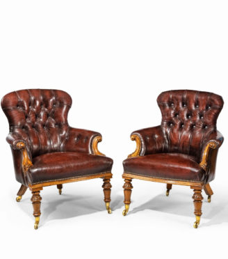 A pair of Victorian walnut library armchairs