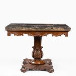 Anglo-Indian mahogany table with Nero portoro marble top by White and Co Calcutta, all on an X-shaped base with scroll feet front