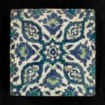 An Ottoman Empire Damascus square tile, late 16th century, the glazed fritware body painted in underglaze green, blue, turquoise and black with four lobed medallions and four split palmettes centred on an eight-pointed floral star, mounted . Syrian.