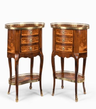 A pair of French rosewood occasional tables, each of oval form with three small drawers set upon cabriole legs joined by a kidney-shaped shelf, decorated in boxwood and kingwood marquetry with oriental landscapes showing a courtly boat on a lake between two pagodas and further landscapes on the sides, back and shelf. Circa 1900.