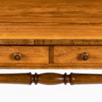 A late Regency rosewood end support table Gillows or Holland and Sons, the rounded rectangular top set above a frieze with two drawers on one side and dummy drawers on the other, the solid end supports. details