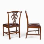 An extensive set of 34 mahogany chairs by Charles Baker, comprising four carvers and 30 side chairs side