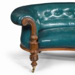 A Victorian carved walnut leathered sofa arm