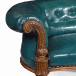 A Victorian carved walnut leathered sofa