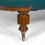 A Victorian carved walnut leathered sofa leg