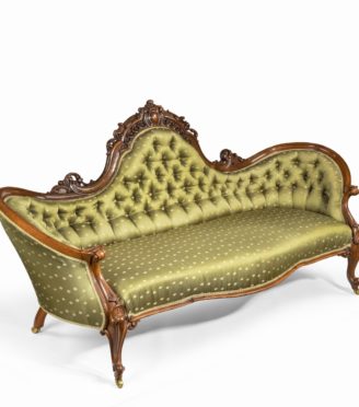 An elaborate Victorian shaped walnut sofa