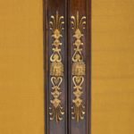 A pair of Regency brass-inlaid rosewood side cabinets doors