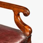 A rosewood library chair in the manner of Henry Holland made for the Senior Service Club arm