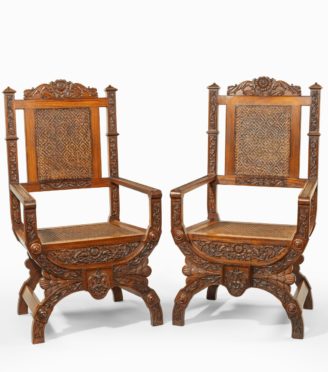 A pair of Indian throne chairs, carved with the arms of the Kingdom of Travancore