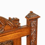 A pair of Indian throne chairs, carved with the arms of the Kingdom of Travancore top detail