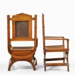A pair of Indian throne chairs, carved with the arms of the Kingdom of Travancore side profile