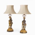 A very fine pair of mid-Victorian parcel gilt bronze oil lamps, by Hinks with shades