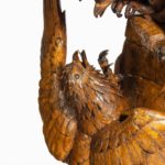 A ‘Black Forest’ carving of two quarrelling golden eagles details