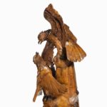 A ‘Black Forest’ carving of two quarrelling golden eagles close up