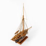 A shipyard model of a gaff-rigged Newhaven Smack, the hull carved from the solid with a scored deck,