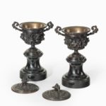 A pair of bronze vases and covers in the classical style lids off