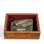 A George III silver bosun’s pipe and chain on H.M.S. Victory oak, 1796 boxed