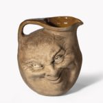A Martinware double-sided stoneware pottery ‘face’ jug bottom dated 1896 front