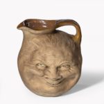 A Martinware double-sided stoneware pottery ‘face’ jug bottom dated 1896