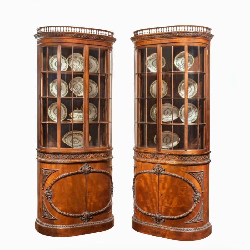 A pair of mahogany shaped display cabinets attributed to Gillows main